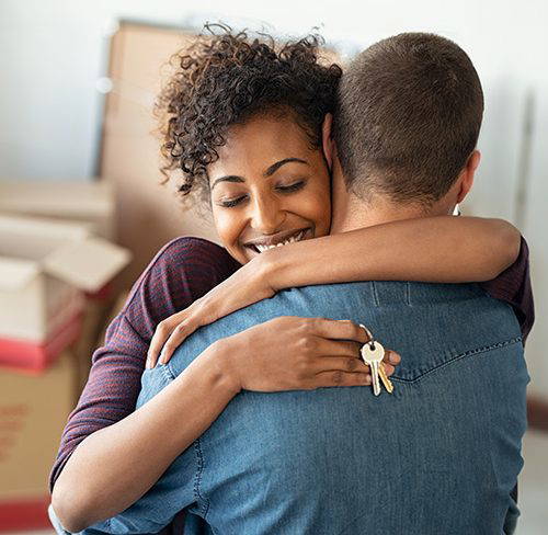 a couple with keys moved into a new home